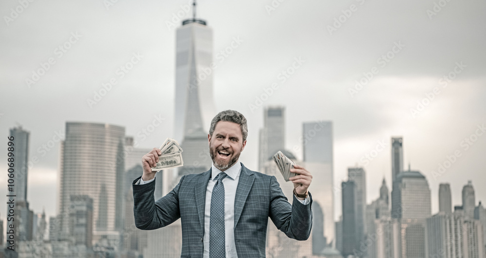 Mature Businessman with dollars money. Excited manager with dollar money on street. Rich business man in suit hold dollar cash. Businessman hold 100 dollars banknotes at city. Dollars banknote. Mature Businessman with dollars money. Excited manager with dollar money on street. Rich business man in suit hold dollar cash. Businessman hold 100 dollars banknotes at city. Dollars banknote.