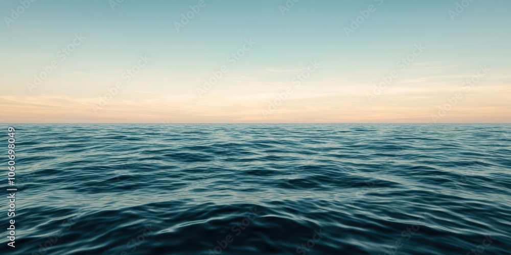Fototapeta premium Calm ocean waves under a clear sky at dusk.