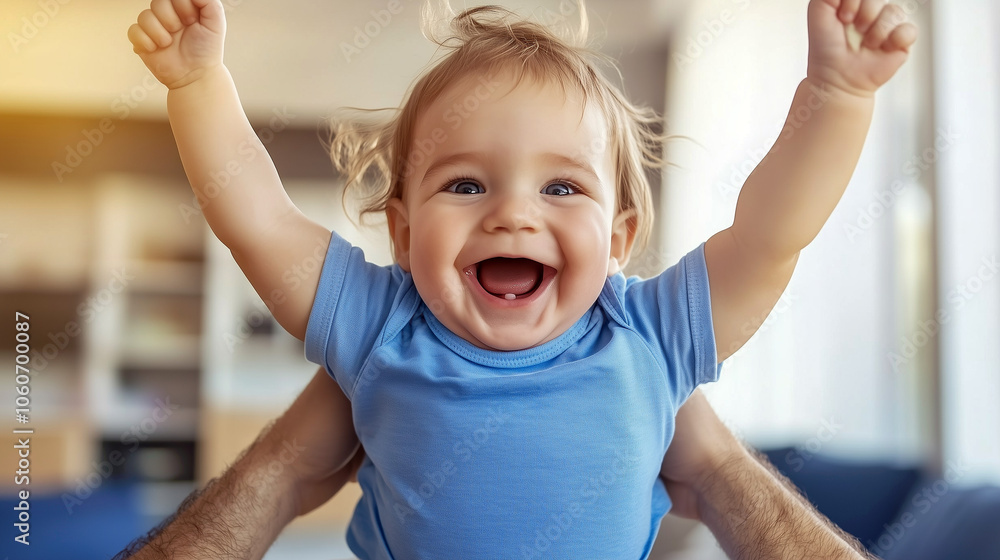 Joyful baby celebrating with raised arms while being held by a parent in a bright indoor setting, showcasing happiness and connection Joyful baby celebrating with raised arms while being held by a parent in a bright indoor setting, showcasing happiness and connection