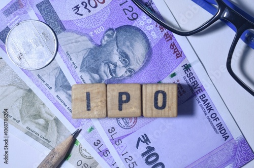 A closeup picture of Letters IPO against the Indian currency notes. Initial public offering is related to Stock market