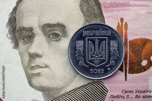 Ukrainian silver coin lies on one hundred hryvnia bill. Financial and business concept. Modern actual ukrainian money photo