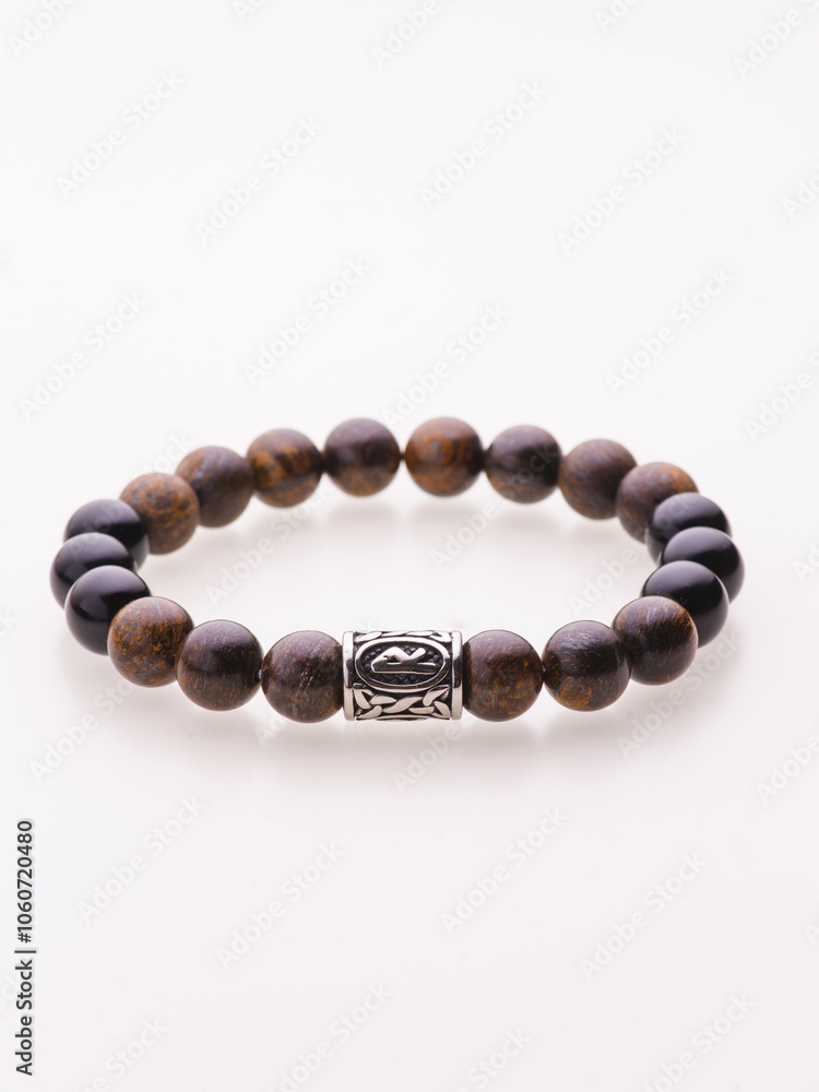 A charming double bracelet in shades of pink, made from natural stone and set against a gray background. The heart charm with cubic zirconia stands out in this close-up top view A charming double bracelet in shades of pink, made from natural stone and set against a gray background. The heart charm with cubic zirconia stands out in this close-up top view