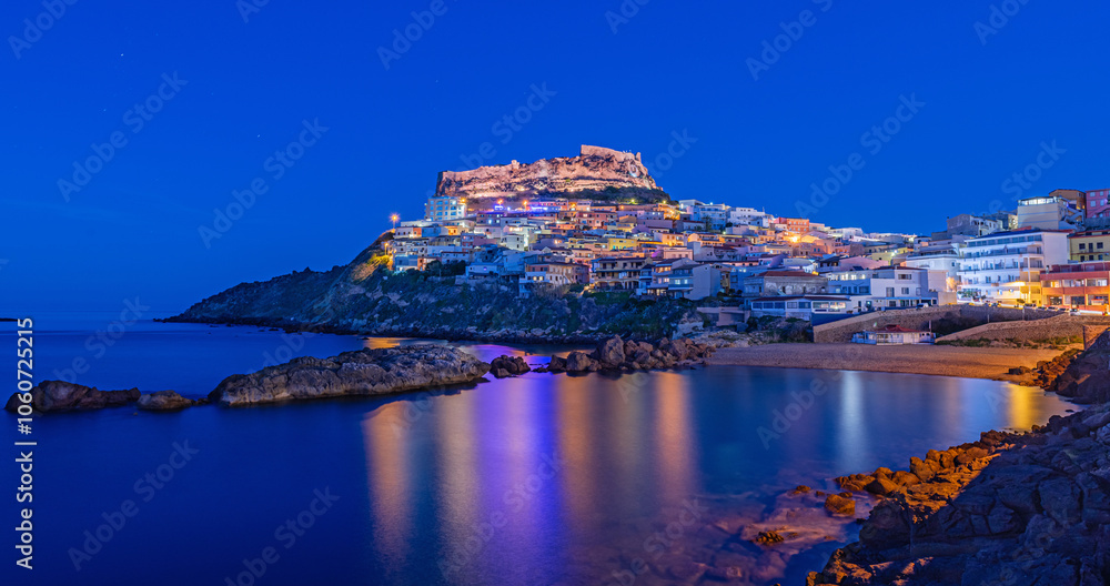 Fototapeta premium Picturesque panoramic view of medieval town of Castelsardo at night, during the blue hour, Province of Sassari, Sardinia, Italy, Europe.
