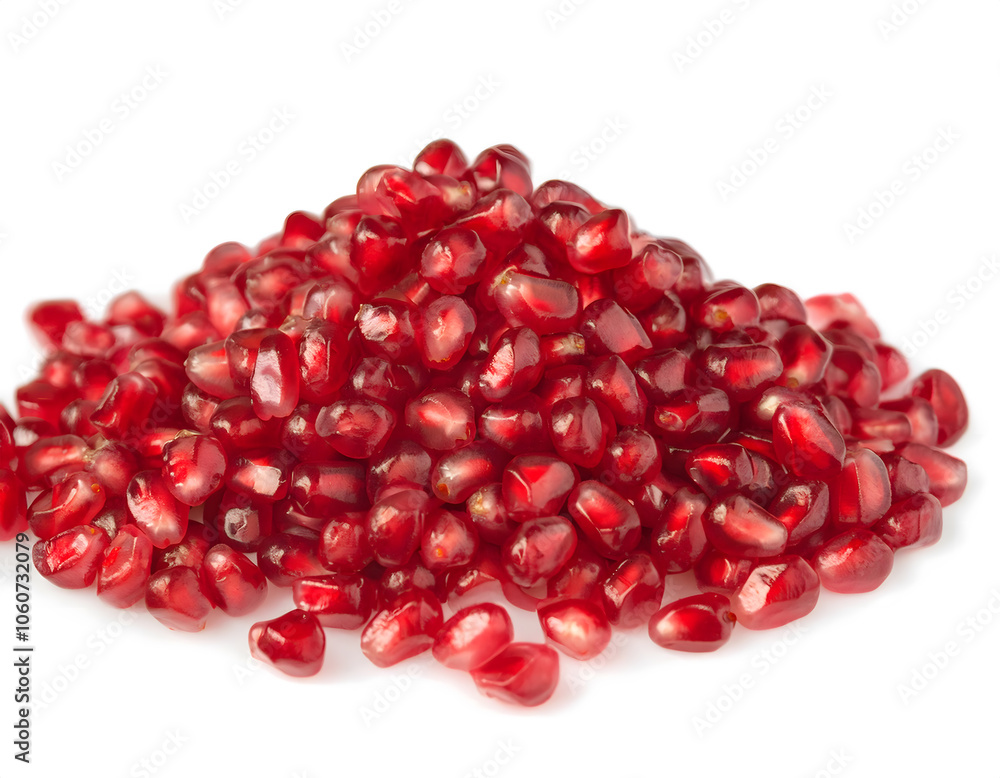 A bunch fruits of small red grains pomegranate seeds on white background. A bunch fruits of small red grains pomegranate seeds on white background.