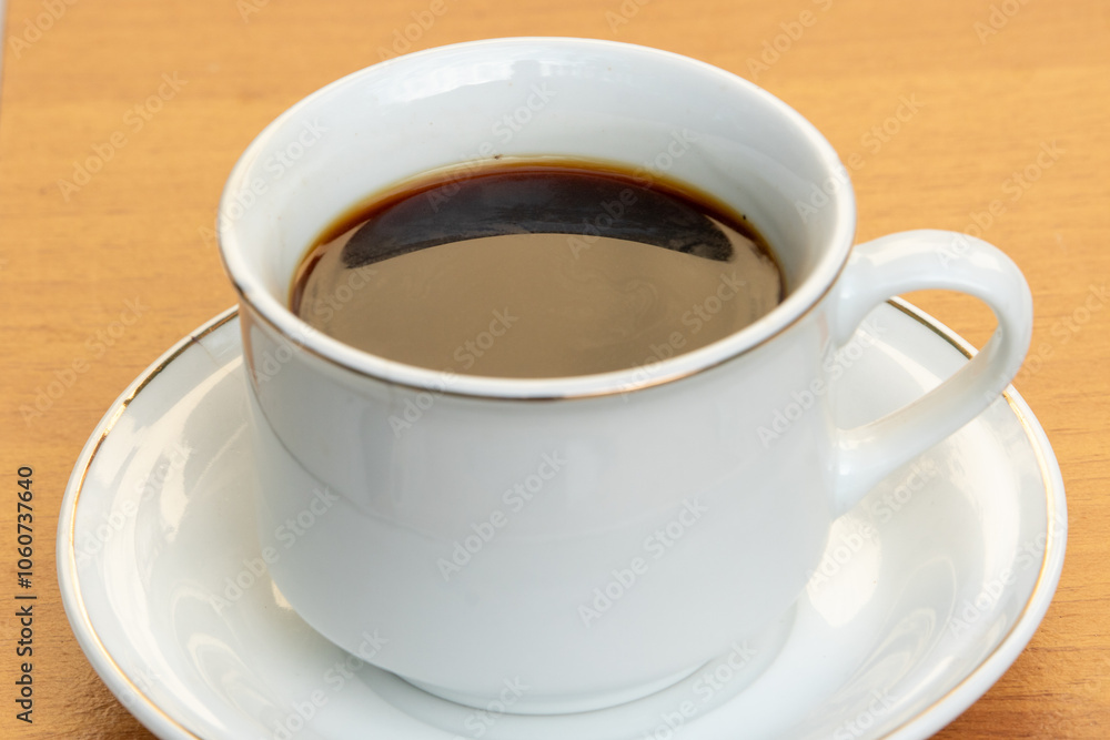 Black Coffee in Ceramic Cup on Wooden Table Black Coffee in Ceramic Cup on Wooden Table