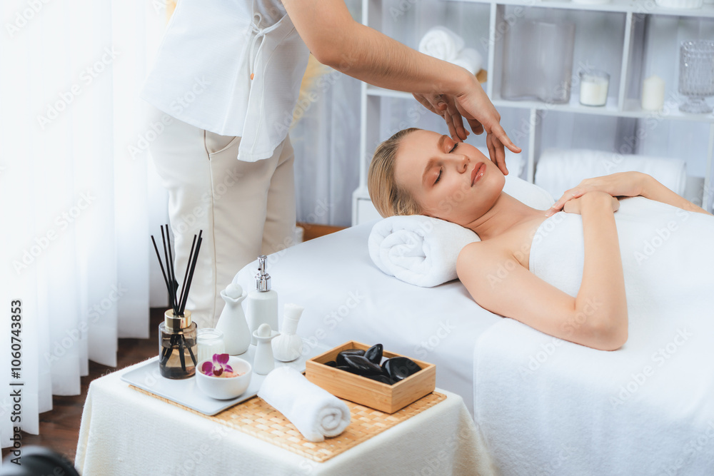 Obraz premium Caucasian woman enjoying relaxing anti-stress head massage and pampering facial beauty skin recreation leisure in dayspa modern light ambient at luxury resort or hotel spa salon. Quiescent