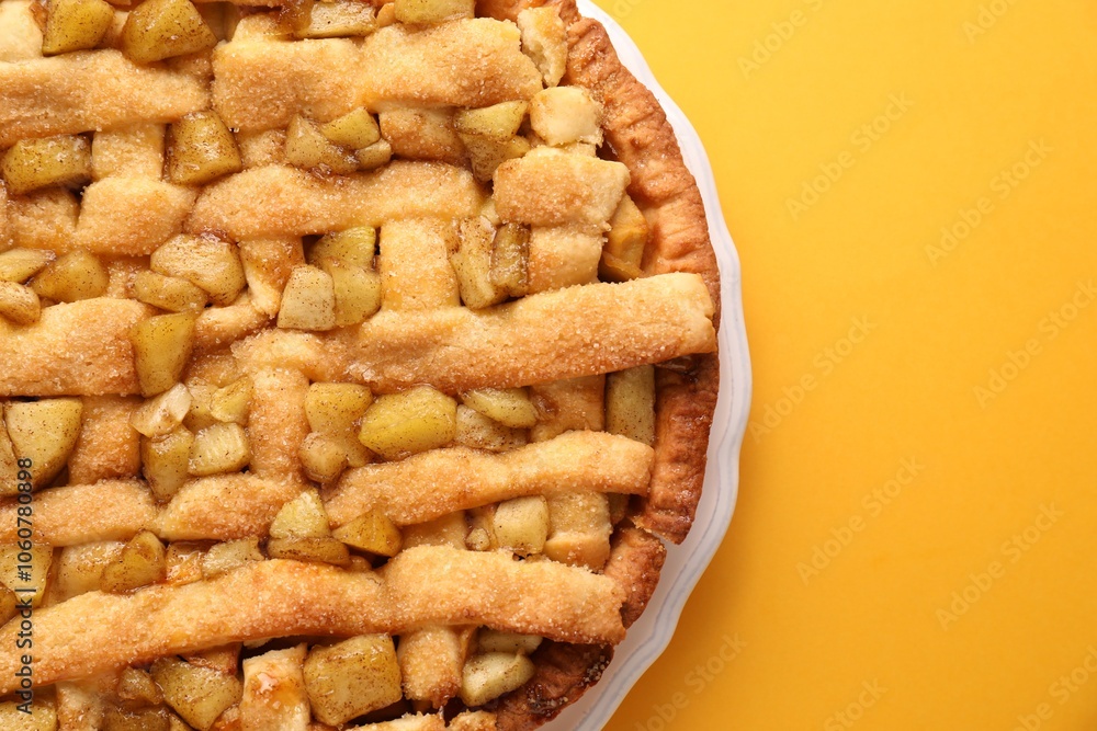Tasty homemade apple pie on yellow background, top view. Space for text Tasty homemade apple pie on yellow background, top view. Space for text