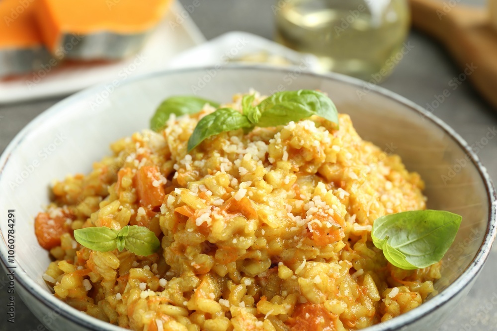 Delicious pumpkin risotto with basil on table, closeup Delicious pumpkin risotto with basil on table, closeup