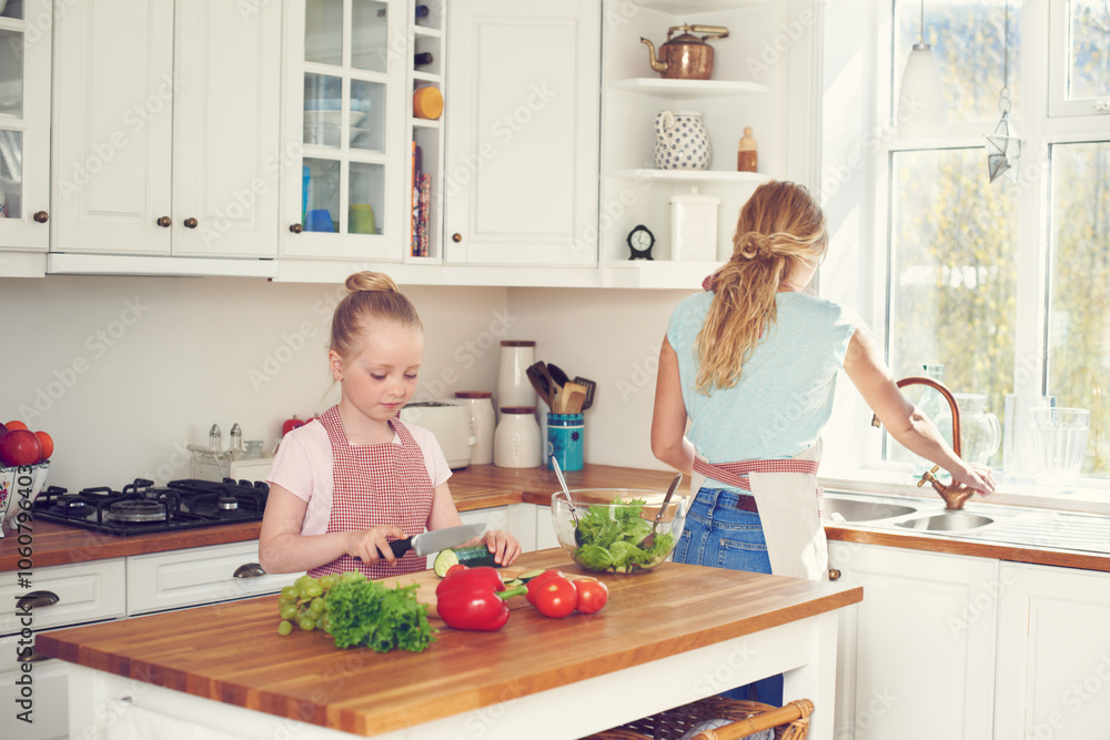 Mother, child and cutting vegetables for salad in kitchen with ingredients, meal prep and learning healthy vegan recipe. Woman, girl and cooking together for culinary skills and helping hand in home Mother, child and cutting vegetables for salad in kitchen with ingredients, meal prep and learning healthy vegan recipe. Woman, girl and cooking together for culinary skills and helping hand in home