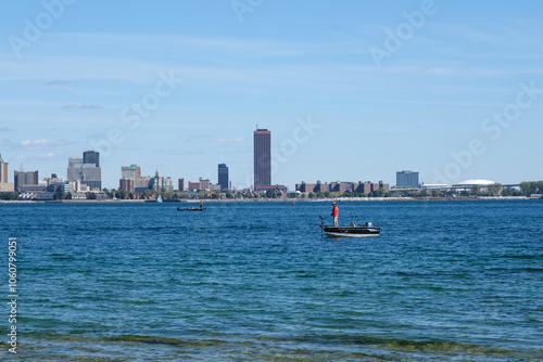 Man fishing from the boat on the Niagara river, in front of Buffalo USA 