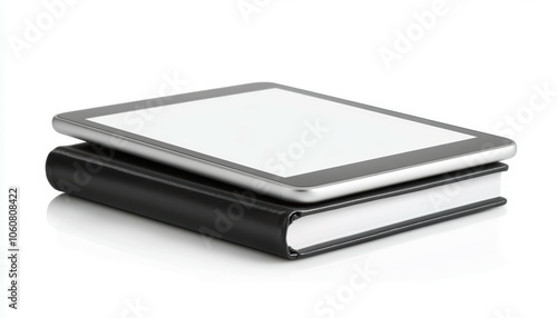 Modern tablet on top of a closed notebook, showcasing technology and education. Ideal for office, study, or digital learning themes.