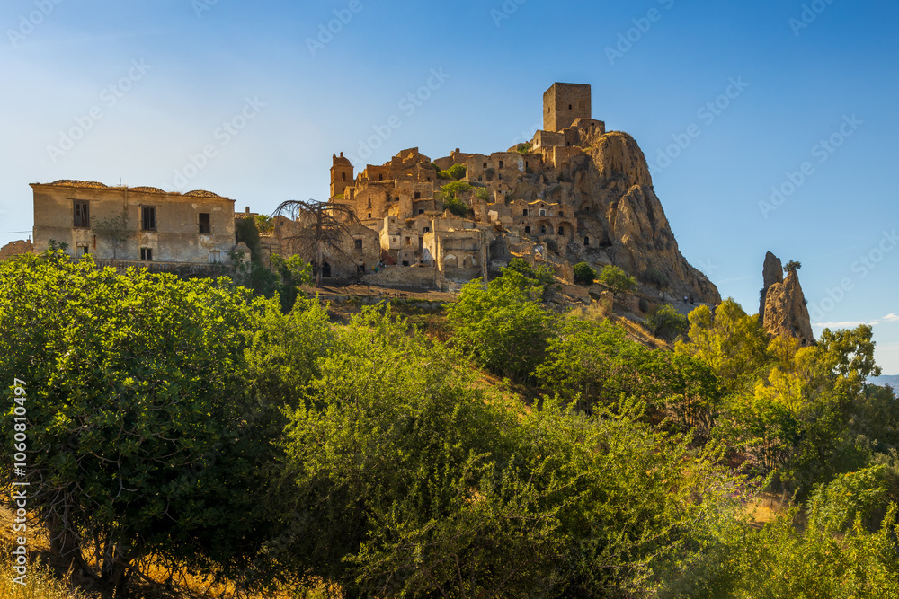 A picturesque view of the abandoned, old mountain town of Craco, built of sandstone rock. Craco is a ghost town abandoned due to an earthquake in the late 20th century. Province of Matera, Basilicata,