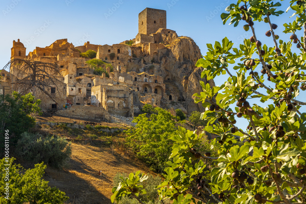 A picturesque view of the abandoned, old mountain town of Craco, built of sandstone rock. Craco is a ghost town abandoned due to an earthquake in the late 20th century. Province of Matera, Basilicata,