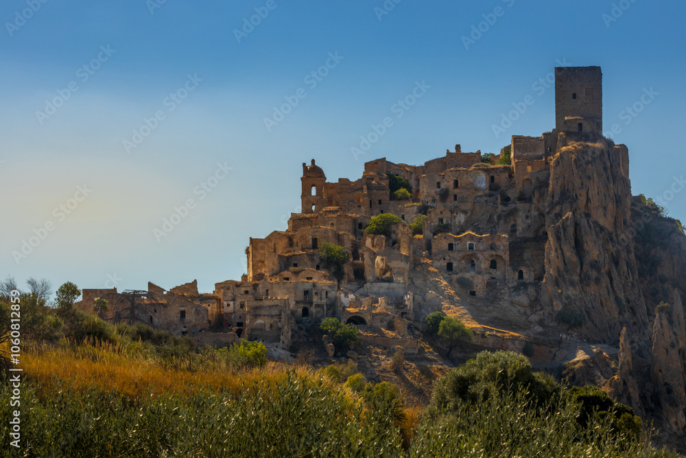 A picturesque view of the abandoned, old mountain town of Craco, built of sandstone rock. Craco is a ghost town abandoned due to an earthquake in the late 20th century. Province of Matera, Basilicata, A picturesque view of the abandoned, old mountain town of Craco, built of sandstone rock. Craco is a ghost town abandoned due to an earthquake in the late 20th century. Province of Matera, Basilicata,