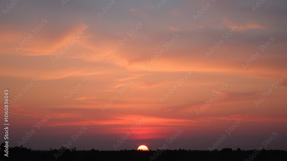Vibrant orange and pink hues paint the sky as the sun sets over a silhouetted landscape, peaceful, landscape Vibrant orange and pink hues paint the sky as the sun sets over a silhouetted landscape, peaceful, landscape