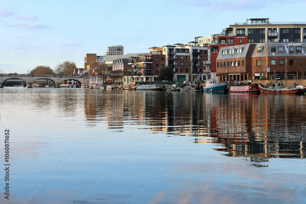 Fototapeta premium Mirror-like reflection of Kingston Upon Thames quayside on the River Thames