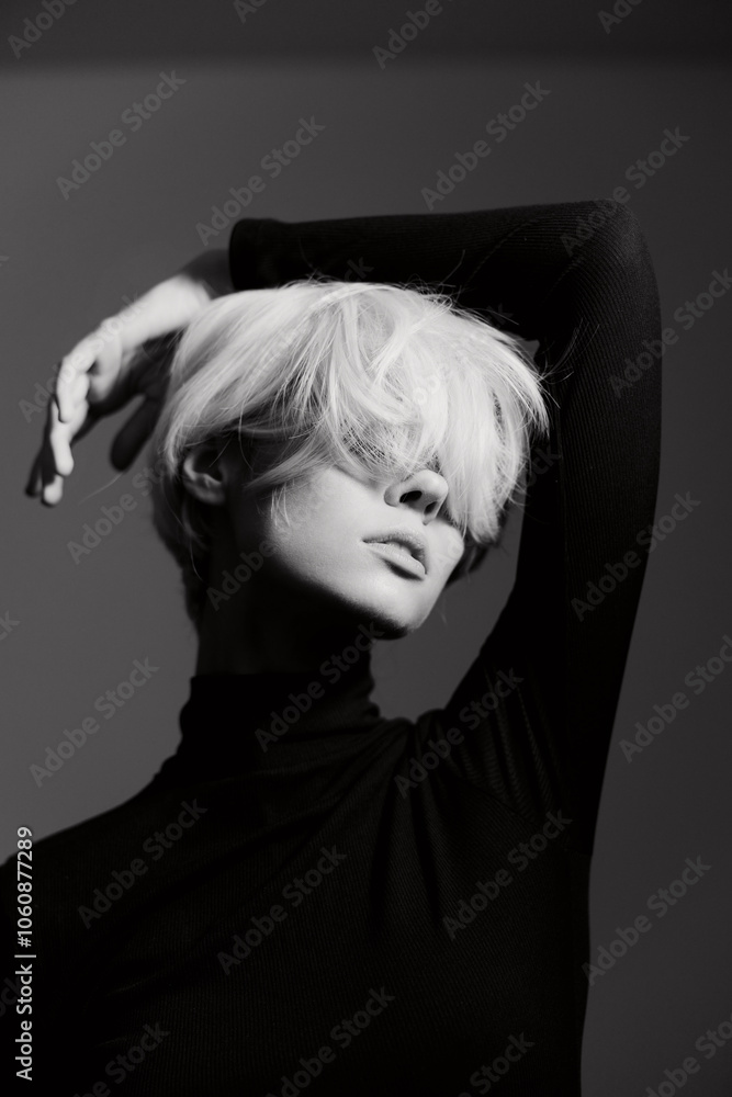 Stylish young woman with short blonde hair posing elegantly in a black turtleneck, showcasing modern fashion and self-expression against a minimalist backdrop. Stylish young woman with short blonde hair posing elegantly in a black turtleneck, showcasing modern fashion and self-expression against a minimalist backdrop.