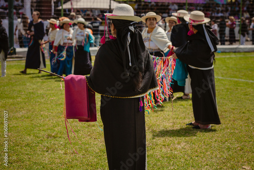 Grupo de mujeres bailando con su atuendo tradicional durante la fiesta del florecimiento llamado Pawkar Raymi en la comunidad de Peguche, Otavalo, Imbabura, Ecuador, Sur América. photo