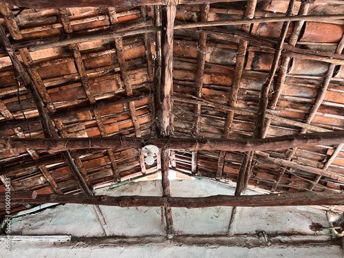 Internal view of the ceiling of a colonial house with wooden structure and mud tiles