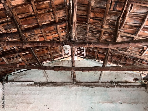 Internal view of the ceiling of a colonial house with wooden structure and mud tiles