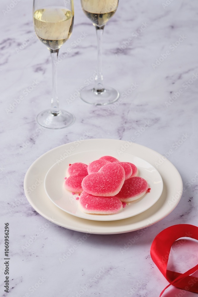 Heart-shaped marmalade on a white plate on a marble background. Valentine's Day concept. Heart-shaped marmalade on a white plate on a marble background. Valentine's Day concept.