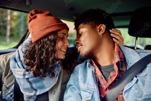 Young affectionate couple inside of car. photo