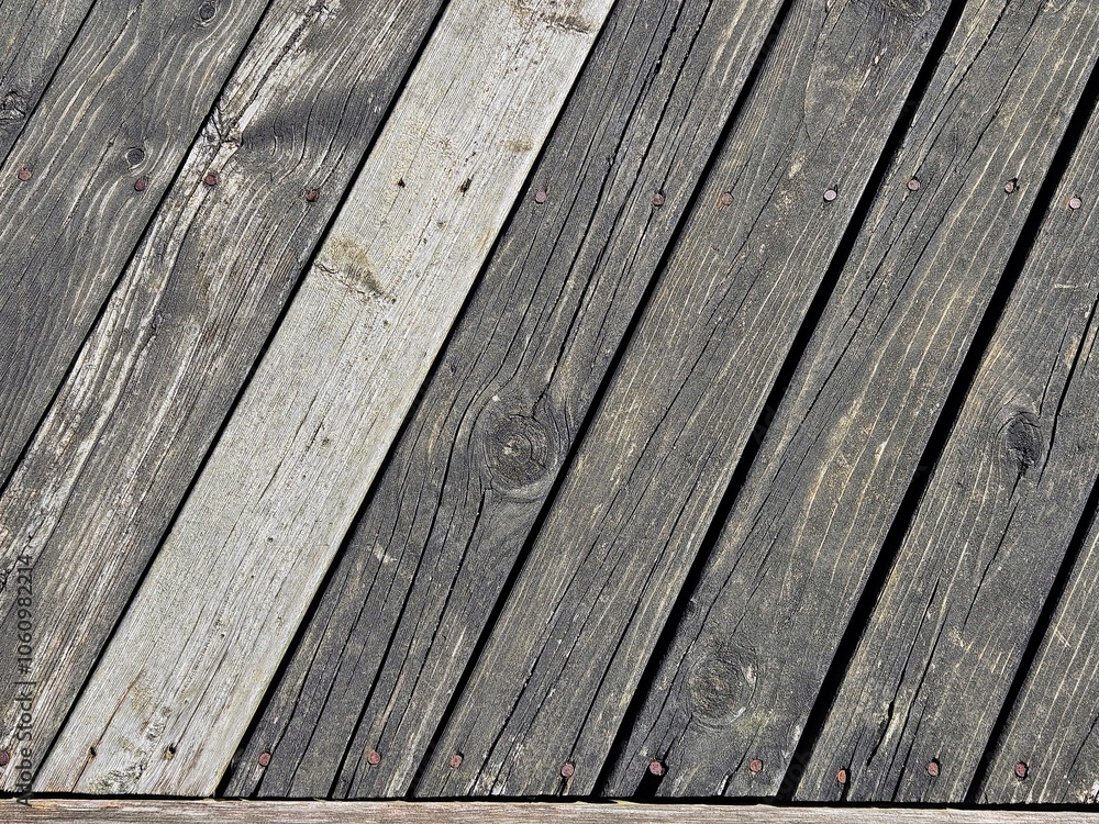 Weathered wood planks nailed in a diagonal pattern. Weathered wood planks nailed in a diagonal pattern.