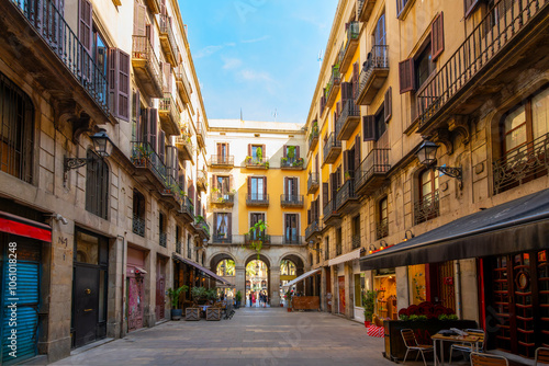 Fototapeta Naklejka Na Ścianę i Meble -  The historic Passatge Madoz, a small arched passage way in the Gothic Quarter leading to the outdoor Placa Reial in the medieval old town of Barcelona, Spain.