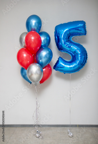 blue number 5 foil balloon and a bunch of helium balloons