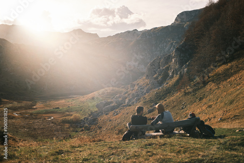 Beautiful mountain landscape with people hiking under the sun 