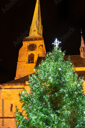 A festive scene with Christmas decorations in the foreground and the Cathedral of St. Bartholomew in Plzen, Czech Republic, in the background. A charming mix of tradition and holiday spirit
