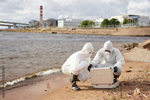 Fotografia Wide angle view at two of unrecognizable scientists wearing hazmat suits and ope