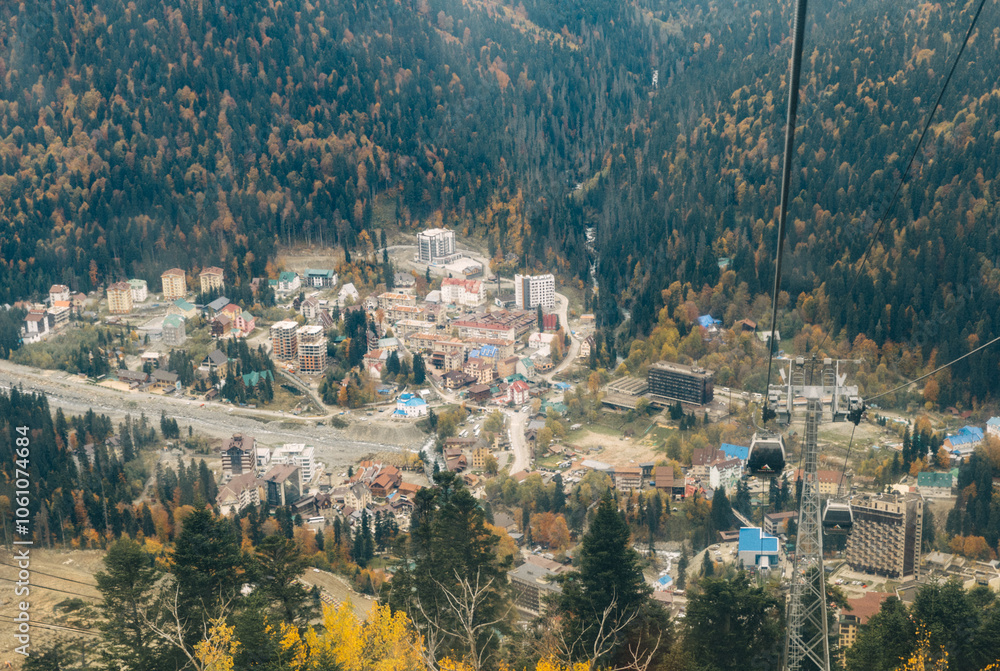 Obraz premium View from Mount Mussa-Achitara to the village of Dombay and the cable car. Dombay is the most famous ski resort and the center of mountaineering and tourism in the Caucasus.
