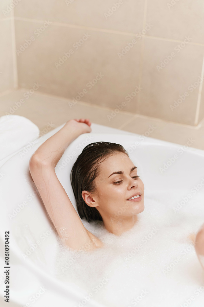 Relaxed woman enjoying a bubble bath, smiling and unwinding after a long day. Peace and self-care concept with soft lighting and warm tones. Relaxed woman enjoying a bubble bath, smiling and unwinding after a long day. Peace and self-care concept with soft lighting and warm tones.