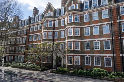 Red bricks houses on Hans Crescent street in Royal Borough of Kensington and Chelsea, London, UK