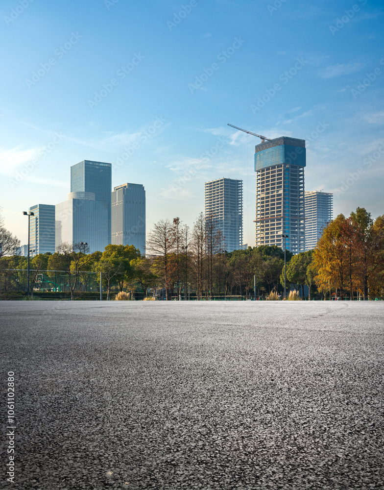 Fototapeta premium Modern Urban Skyline with New Construction and Autumn Trees