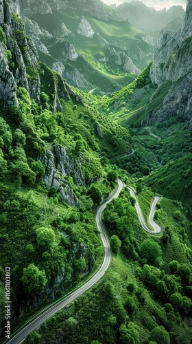 Winding curvy mountain road weaving its way through the lush verdant tropical jungle landscape with moody atmospheric scenery of misty clouds dramatic cliffs and breathtaking vistas photo