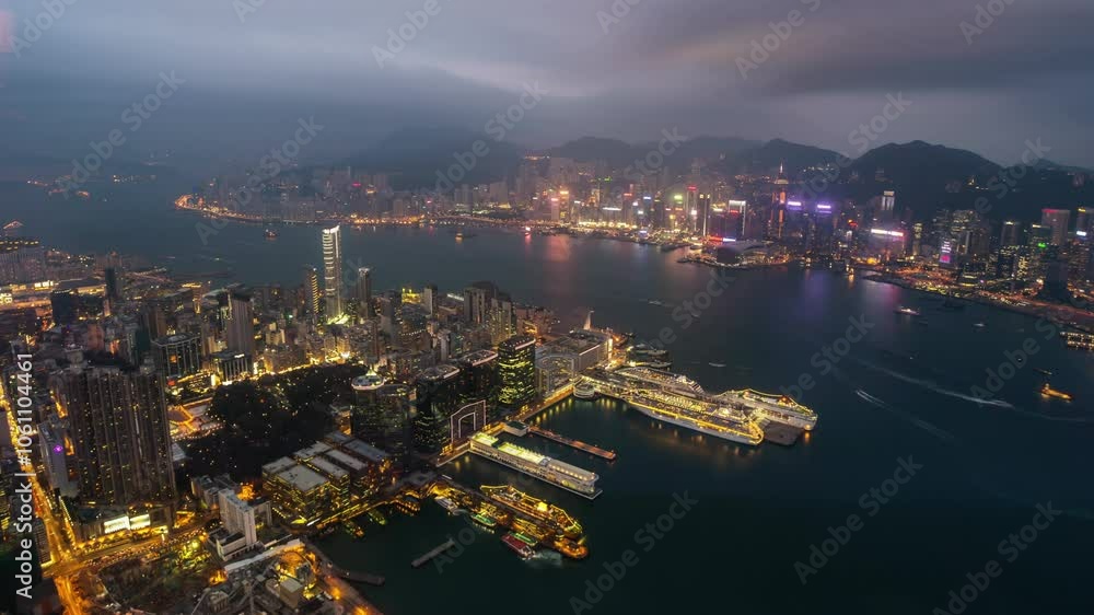 HONG KONG, - OCTOBER 27, 2024: Expansive aerial view of Hong Kongs skyline with harbor and mountains capturing the dynamic cityscape during twilight HONG KONG, - OCTOBER 27, 2024: Expansive aerial view of Hong Kongs skyline with harbor and mountains capturing the dynamic cityscape during twilight