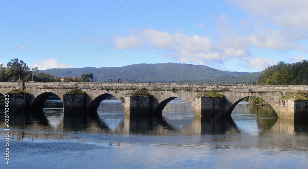 Ancient bridge on a river located in Pontevedra, Spain, reflection in the water, pilgrimage to Santiago Ancient bridge on a river located in Pontevedra, Spain, reflection in the water, pilgrimage to Santiago