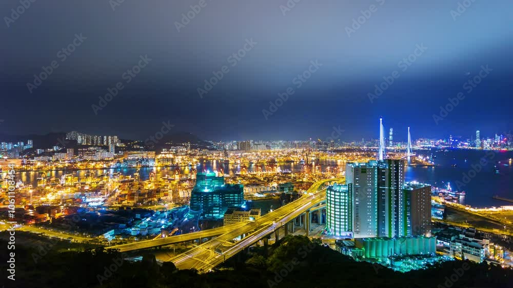 HONG KONG, - OCTOBER 27, 2024: Illuminated harbor view showcasing bustling shipping activity and vibrant city skyline at night HONG KONG, - OCTOBER 27, 2024: Illuminated harbor view showcasing bustling shipping activity and vibrant city skyline at night