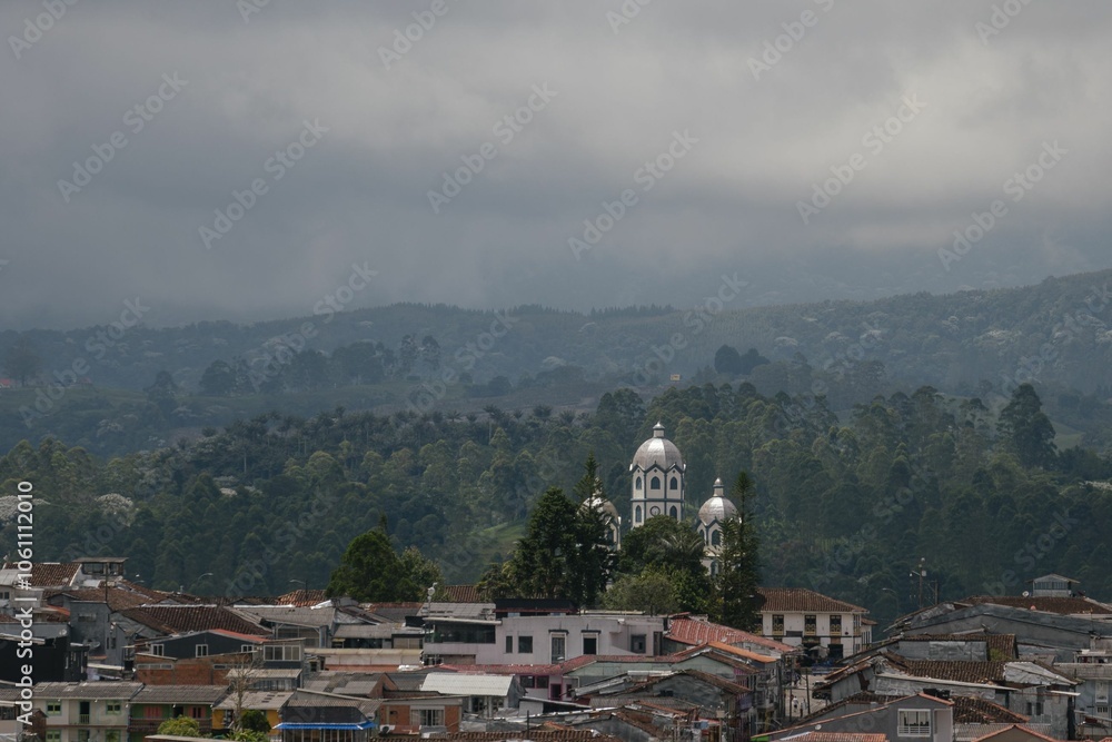 Obraz premium Townscape with Church and Lush Greenery