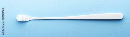 White Tongue Scraper on a Light Blue Background photo