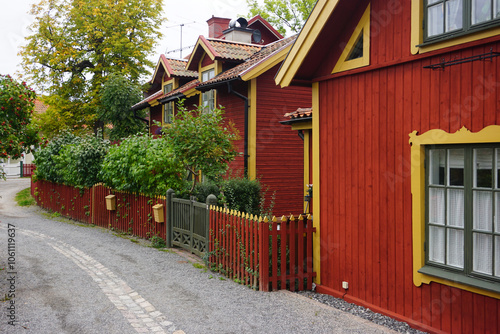 View of road next to red buildings in Vaxholm photo