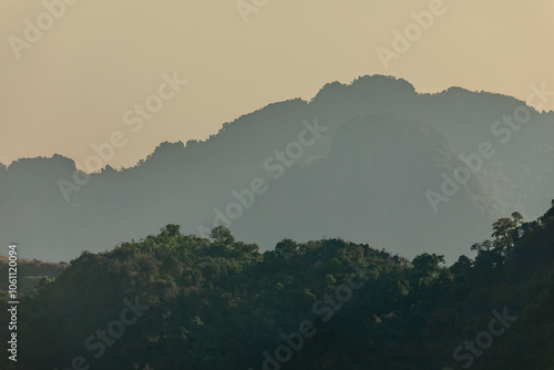 Landscape of karst mountains covered with rainforests, at sunset, seen from Pha Ngern Viewpoint, near Vang Vieng, Laos, Southeast Asia, adventure or travel concept in nature photo