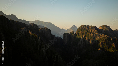 Landscape of karst mountains covered with rainforests, at sunset, seen from Pha Ngern Viewpoint, near Vang Vieng, Laos, Southeast Asia, adventure or travel concept in nature photo