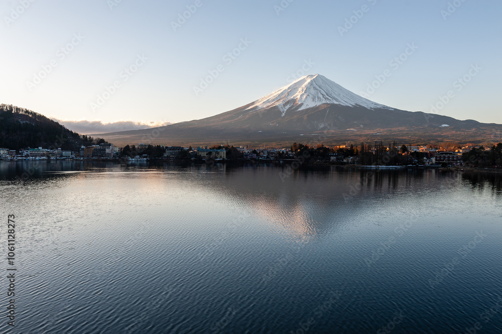Mount Fuji on a bright winter morning, as seen from across lake Kawaguchi, and the nearby town of Kawaguchiko. Mount Fuji on a bright winter morning, as seen from across lake Kawaguchi, and the nearby town of Kawaguchiko.