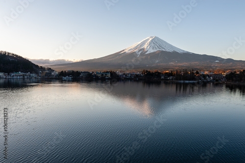 Mount Fuji on a bright winter morning, as seen from across lake Kawaguchi, and the nearby town of Kawaguchiko. photo