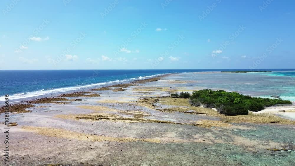 Drone view of a beach with waves on the Maldives with the dreamlike blue of the ocean and the view of the horizon. Drone view of a beach with waves on the Maldives with the dreamlike blue of the ocean and the view of the horizon.