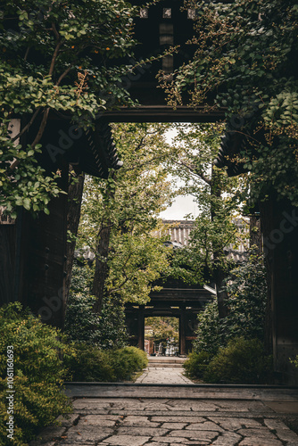 Entrance to an old Japanese temple surrounded by greenery.