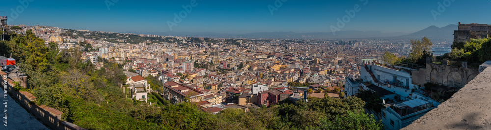 Panoramic view of mount vesuvius and the city of naples below, looking from Sant elmo castle above the city. Summer or autumn scene with majestic volcano view Panoramic view of mount vesuvius and the city of naples below, looking from Sant elmo castle above the city. Summer or autumn scene with majestic volcano view